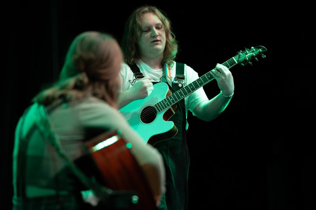 Two singers with guitars.